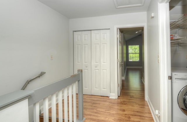 2205 Gladstone Ct, Glendale Heights, IL 60139 - hall with washer / clothes dryer, light wood finished floors, an upstairs landing, vaulted ceiling, and baseboards