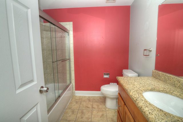 2205 Gladstone Ct, Glendale Heights, IL 60139 - bathroom featuring vanity, toilet, tile patterned floors, combined bath / shower with glass door, and baseboards