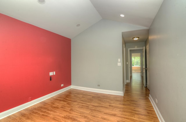 2205 Gladstone Ct, Glendale Heights, IL 60139 - spare room featuring light wood-style flooring, baseboards, and lofted ceiling