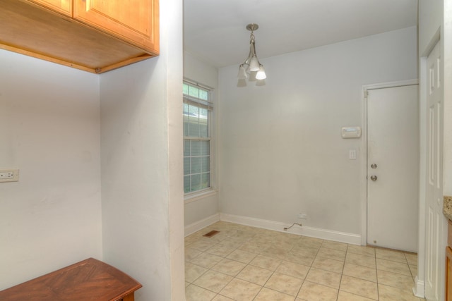 2205 Gladstone Ct, Glendale Heights, IL 60139 - unfurnished dining area featuring light tile patterned flooring and baseboards