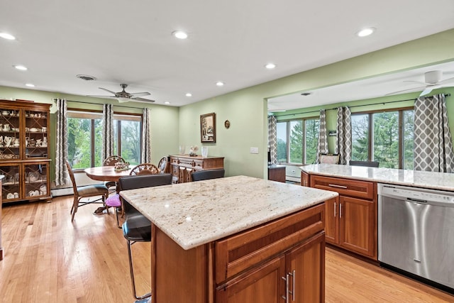 kitchen featuring stainless steel dishwasher, a ceiling fan, plenty of natural light, light wood-style floors, and recessed lighting