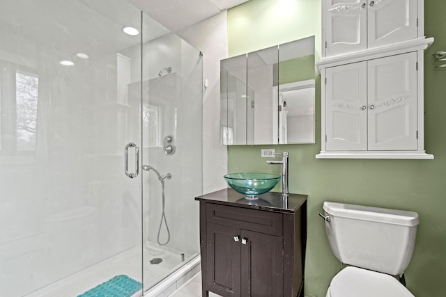 full bath featuring a stall shower, toilet, and vanity