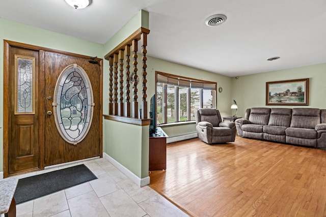 entryway with a baseboard radiator and baseboards