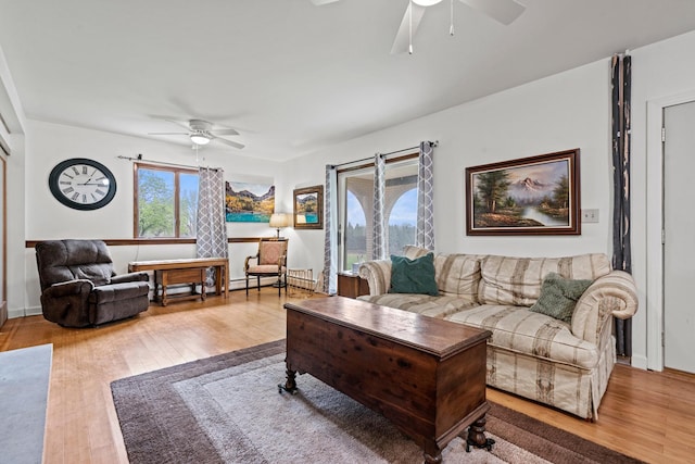 living area featuring a ceiling fan and wood finished floors