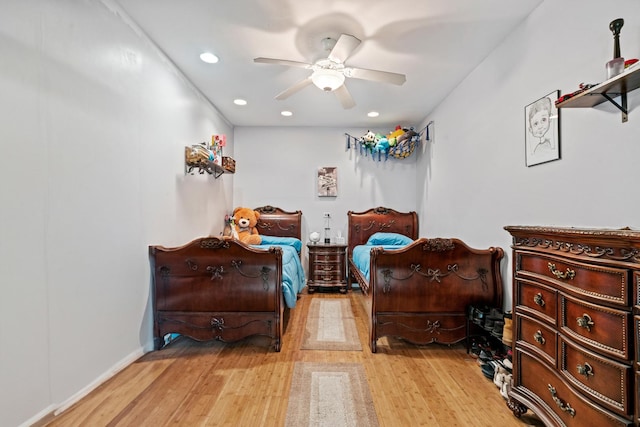 bedroom featuring light wood-type flooring, a ceiling fan, recessed lighting, and baseboards