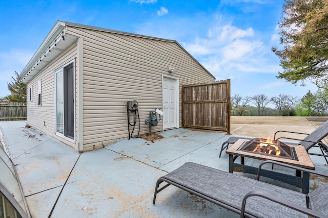view of patio / terrace featuring a fire pit and fence