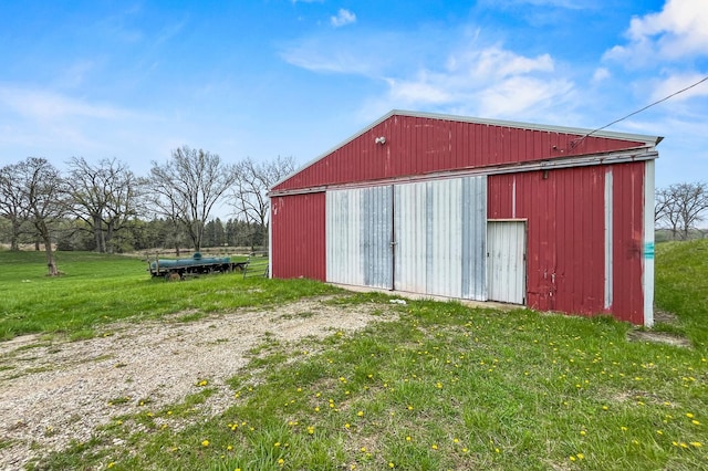 view of pole building with a yard