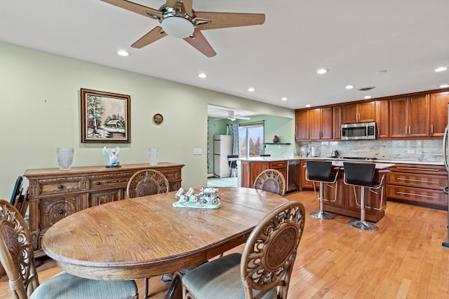 dining space with ceiling fan, light wood-type flooring, and recessed lighting