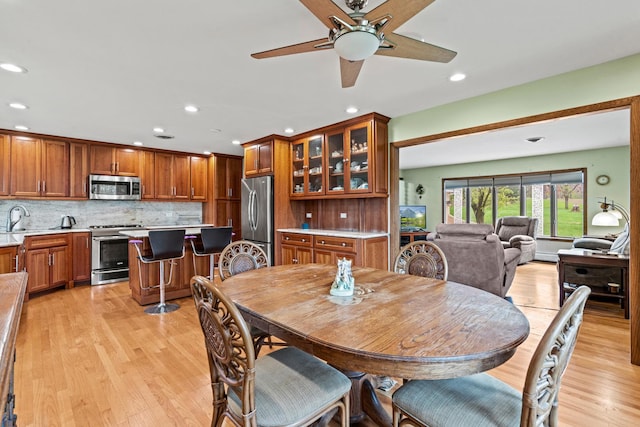 dining room with recessed lighting, light wood-style flooring, and ceiling fan