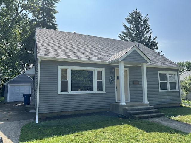 434 Ingleside Ave, Aurora, IL 60506 - view of front of house with an outdoor structure, a front yard, a shingled roof, and driveway