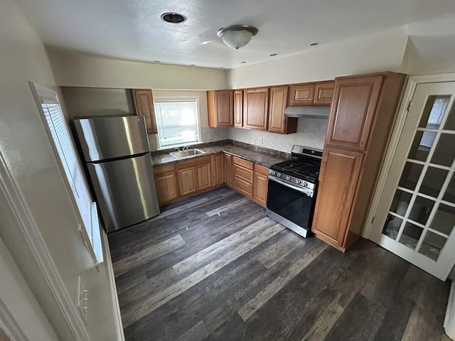 434 Ingleside Ave, Aurora, IL 60506 - kitchen with stainless steel appliances, under cabinet range hood, dark countertops, dark wood-style flooring, and brown cabinetry