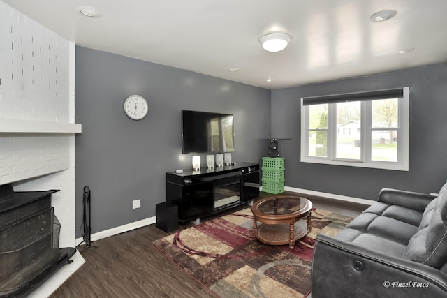 193 Thunderbird Trl, Carol Stream, IL 60188 - living area with a brick fireplace, baseboards, and dark wood-type flooring