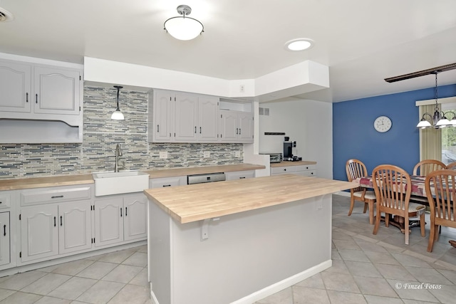 193 Thunderbird Trl, Carol Stream, IL 60188 - kitchen with light tile patterned floors, a sink, wood counters, pendant lighting, and backsplash