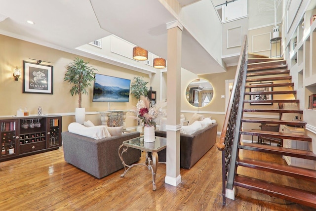 708 N Rockwell St, Chicago, IL 60612 - living room featuring visible vents, crown molding, wood finished floors, stairway, and recessed lighting