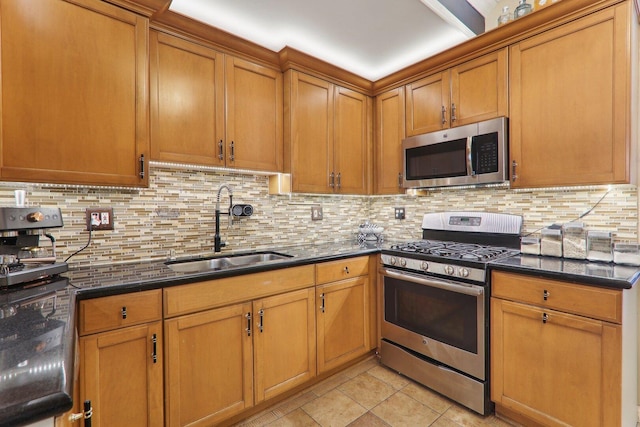 708 N Rockwell St, Chicago, IL 60612 - kitchen with brown cabinets, a sink, dark stone counters, stainless steel appliances, and decorative backsplash