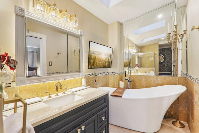708 N Rockwell St, Chicago, IL 60612 - bathroom with a freestanding bath, vanity, tile walls, a skylight, and tiled shower