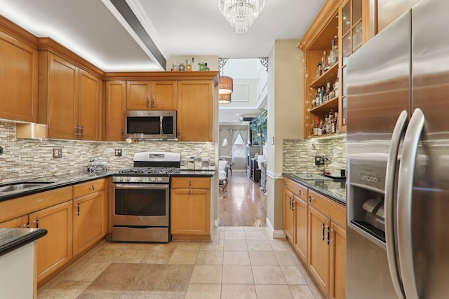708 N Rockwell St, Chicago, IL 60612 - kitchen with brown cabinets, open shelves, appliances with stainless steel finishes, a chandelier, and backsplash