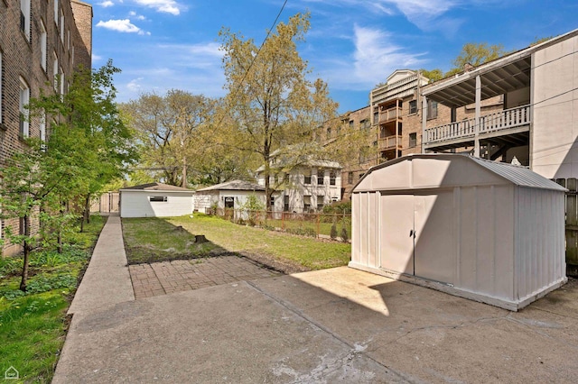 view of patio / terrace with an outdoor structure and a storage unit