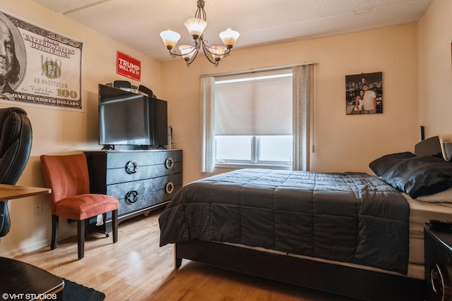 4534 N Cumberland Ave Unit 207, Chicago, IL 60656 - bedroom with a chandelier and light wood-style flooring