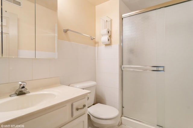 4534 N Cumberland Ave Unit 207, Chicago, IL 60656 - bathroom with tile walls, a shower stall, toilet, and vanity