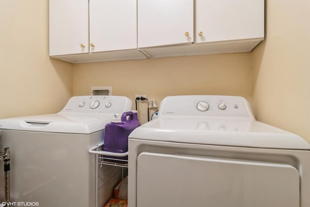 4534 N Cumberland Ave Unit 207, Chicago, IL 60656 - clothes washing area with washer and dryer and cabinet space