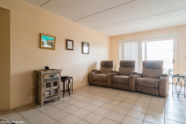 4534 N Cumberland Ave Unit 207, Chicago, IL 60656 - living room with light tile patterned floors, a textured ceiling, and baseboards