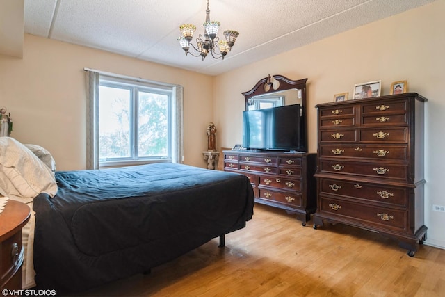 4534 N Cumberland Ave Unit 207, Chicago, IL 60656 - bedroom with a chandelier and light wood-type flooring