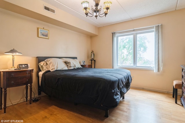 4534 N Cumberland Ave Unit 207, Chicago, IL 60656 - bedroom featuring a chandelier and light wood finished floors