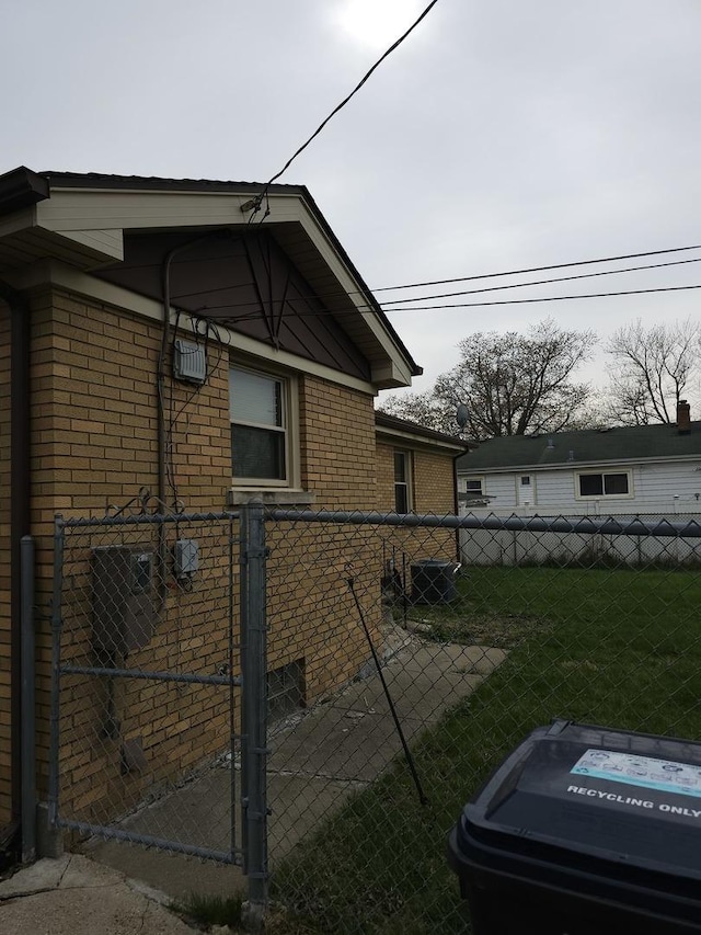 656 E 160th Pl, South Holland, IL 60473 - view of side of home featuring brick siding, a gate, fence, and a yard
