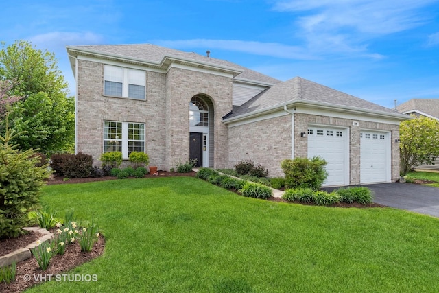 129 S Palmer Dr, Bolingbrook, IL 60490 - view of front facade featuring asphalt driveway, a front yard, a garage, a shingled roof, and brick siding