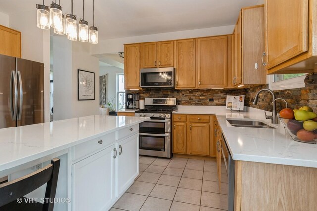 129 S Palmer Dr, Bolingbrook, IL 60490 - kitchen featuring appliances with stainless steel finishes, a sink, decorative backsplash, light tile patterned floors, and light stone counters