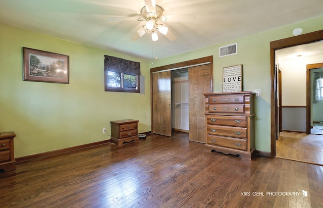 bedroom featuring dark wood finished floors, a closet, and baseboards