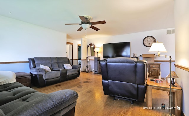 living room featuring a ceiling fan and wood finished floors