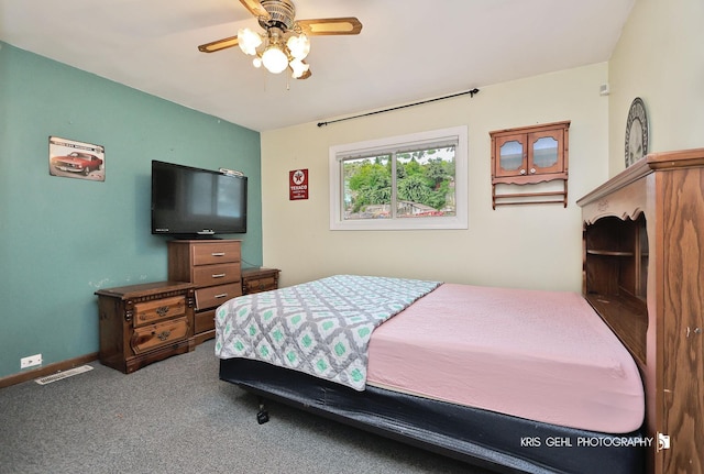 carpeted bedroom featuring baseboards and a ceiling fan