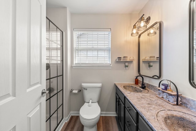 711 W Benham St, Kirkland, IL 60146 - bathroom with wood finished floors, double vanity, and an enclosed shower
