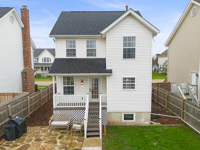 711 W Benham St, Kirkland, IL 60146 - rear view of house with a shingled roof, covered porch, and a fenced backyard