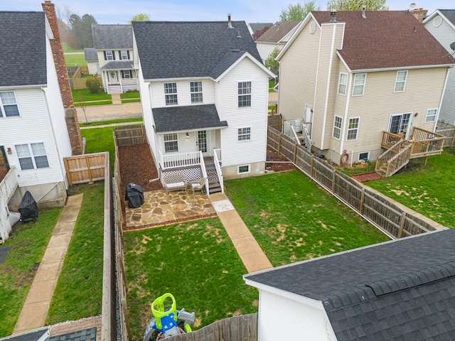 711 W Benham St, Kirkland, IL 60146 - back of property featuring a patio area, a deck, a fenced backyard, a residential view, and a shingled roof