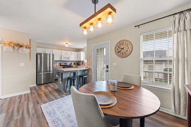 711 W Benham St, Kirkland, IL 60146 - dining area featuring wood finished floors and a chandelier
