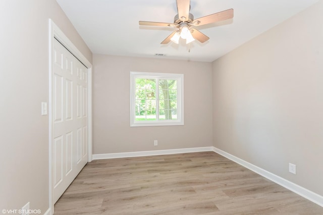 34327 S Lakeside Ter, Wilmington, IL 60481 - unfurnished bedroom with visible vents, a closet, baseboards, light wood-type flooring, and a ceiling fan