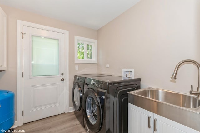 34327 S Lakeside Ter, Wilmington, IL 60481 - clothes washing area with a sink, light wood-style floors, washing machine and dryer, and cabinet space