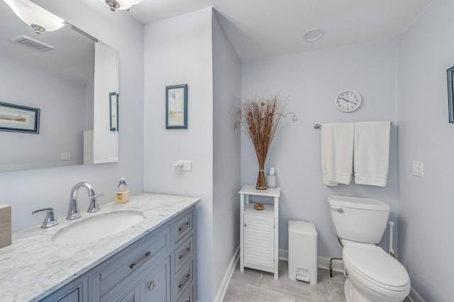 1716 N Beech Rd, Mount Prospect, IL 60056 - bathroom with tile patterned flooring, vanity, toilet, baseboards, and visible vents