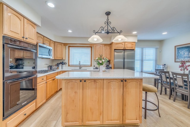 1716 N Beech Rd, Mount Prospect, IL 60056 - kitchen featuring a sink, a center island, light wood-style floors, and stainless steel appliances