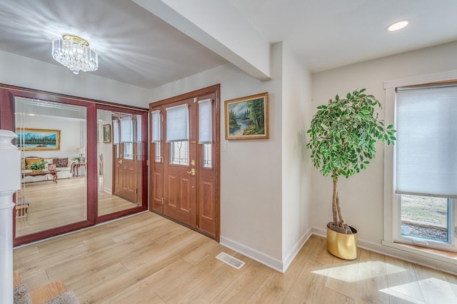 1716 N Beech Rd, Mount Prospect, IL 60056 - foyer entrance with a wealth of natural light, light wood finished floors, and visible vents