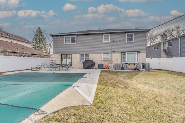 1716 N Beech Rd, Mount Prospect, IL 60056 - back of house with brick siding, a fenced backyard, a patio area, and a yard