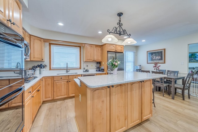 1716 N Beech Rd, Mount Prospect, IL 60056 - kitchen with hanging light fixtures, a sink, light wood-style floors, light brown cabinets, and stainless steel appliances