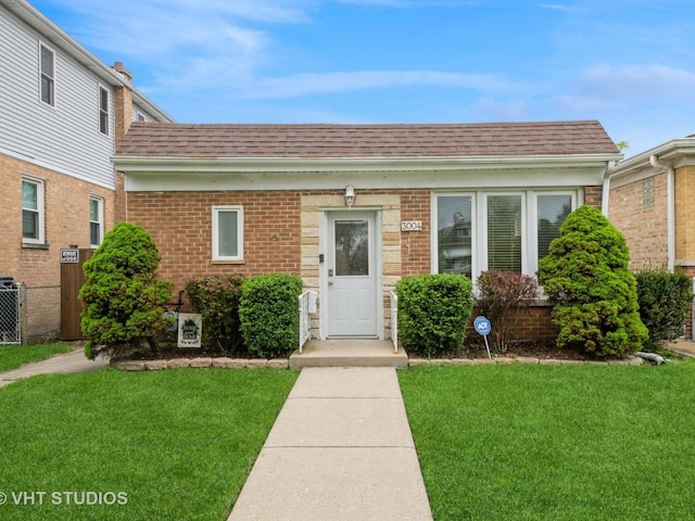 3004 N Olcott Ave, Chicago, IL 60707 - view of front facade featuring a front lawn, roof with shingles, brick siding, and central AC unit