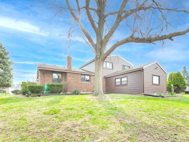 1602 S Surrey Ln, Arlington Heights, IL 60005 - back of house with a lawn, fence, a chimney, and brick siding