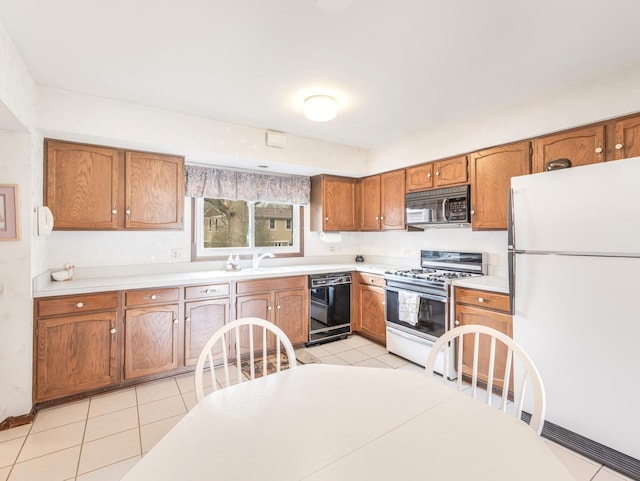 1602 S Surrey Ln, Arlington Heights, IL 60005 - kitchen featuring black appliances, a sink, brown cabinetry, and light countertops