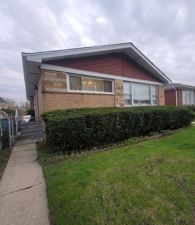 3843 Dempster St, Skokie, IL 60076 - view of property exterior featuring fence, a yard, and brick siding