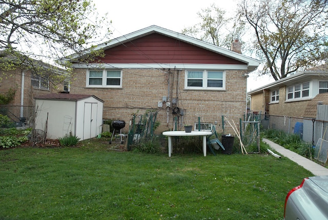 3843 Dempster St, Skokie, IL 60076 - back of house with an outdoor structure, fence, a storage unit, brick siding, and a yard